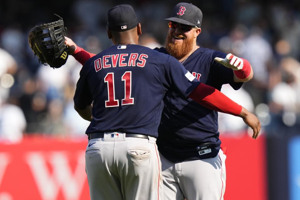 Boston Red Sox's Justin Turner, right, hugs Rafael Devers after a baseball game against the New York Yankees, Sunday, Aug. 20, 2023, in New York. (AP Photo/Frank Franklin II)