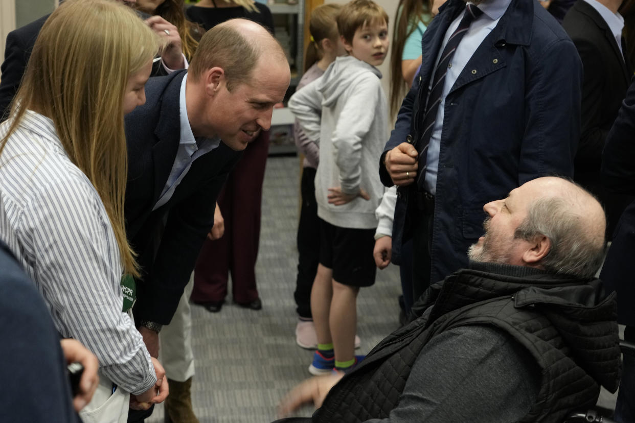 Britain's Prince William talks to a man as he visits an accommodation centre, for Ukrainians who fled the war, in Warsaw, Poland, Wednesday, March 22, 2023. (AP Photo/Czarek Sokolowski)