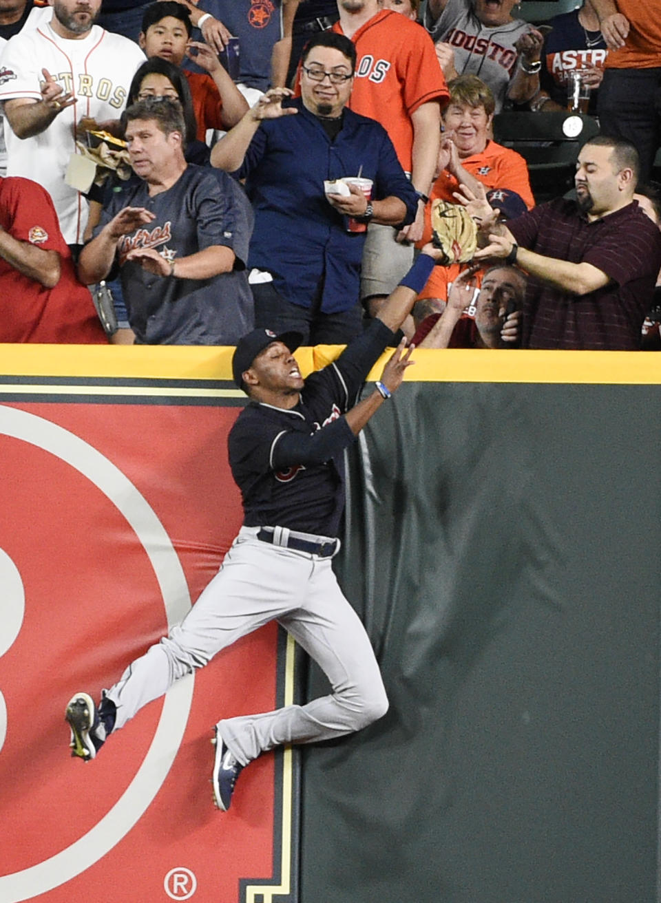 FILE - In this Friday, May 18, 2018 file photo, Cleveland Indians right fielder Greg Allen catches a fly ball hit by Houston Astros' Alex Bregman during the first inning of a baseball game in Houston. Everyone has seen an outfielder receive a tip of the cap or a jubilant fist bump from a pitcher after a home run robbery. This is a story about what happens after they leave the field. (AP Photo/Eric Christian Smith, File)