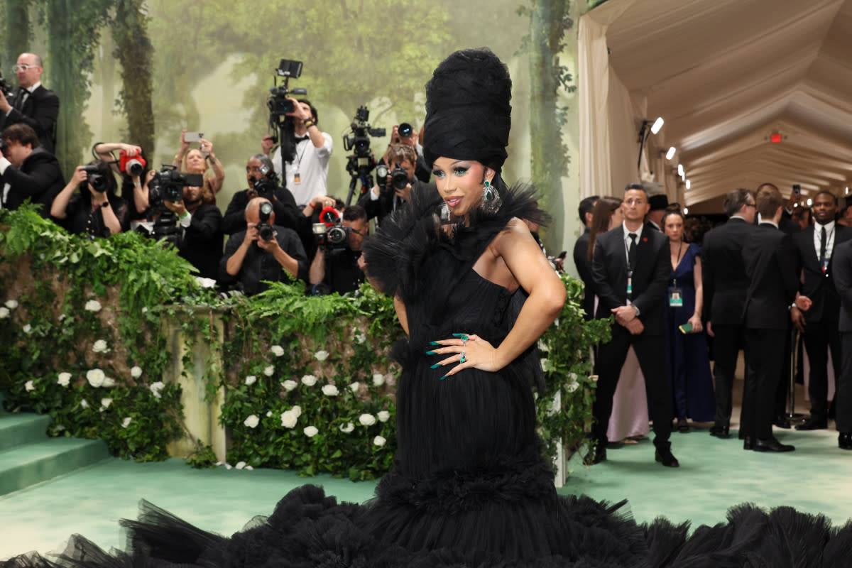 <p>Photo by Dia Dipasupil/Getty Images</p><p>Cardi B closed out the carpet in a voluminous black gown and headpiece. She accessorized with emerald jewels. </p>