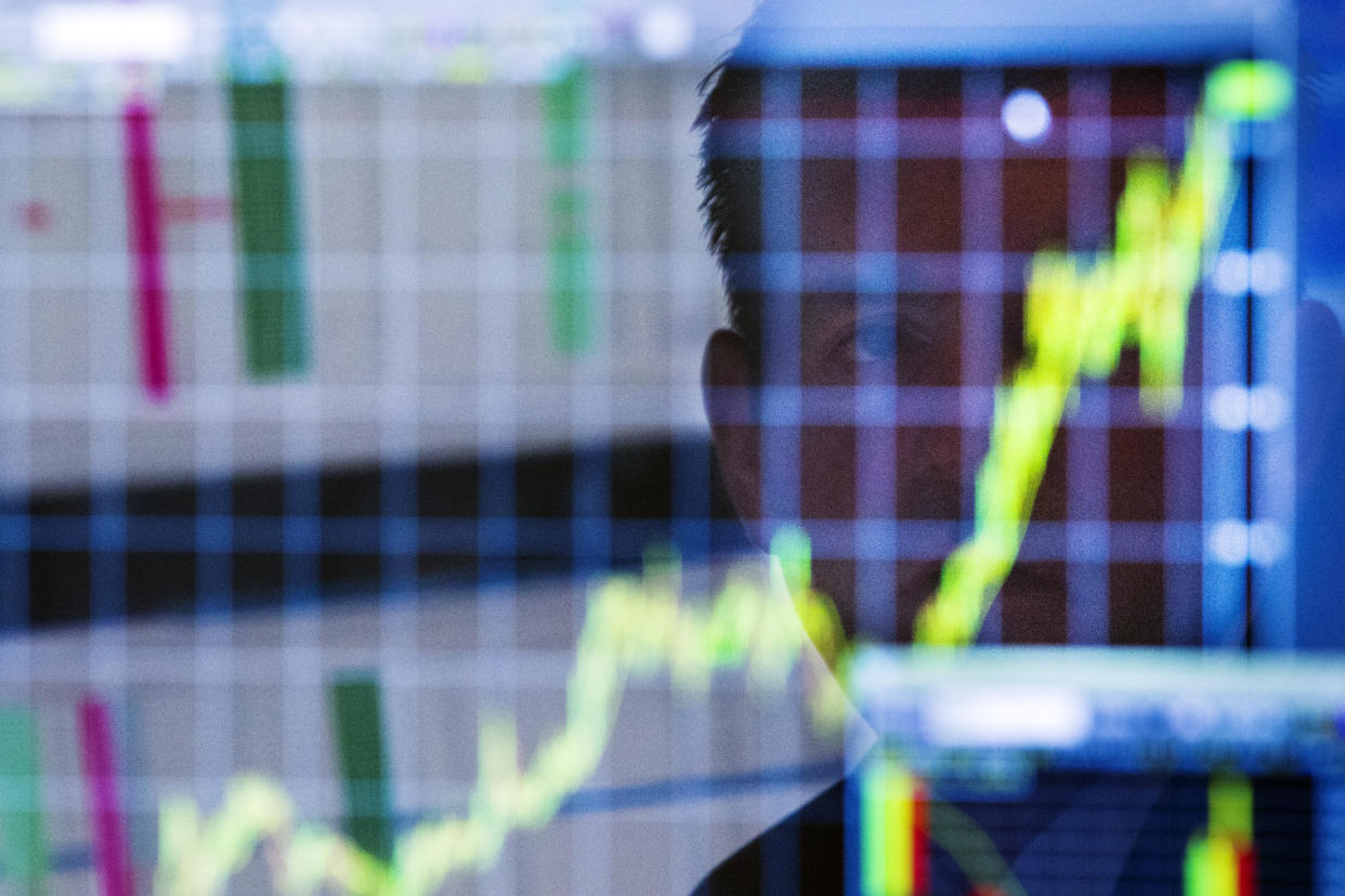 A trader looks up at a chart on his computer screen while working on the floor of the New York Stock Exchange shortly after the market opening in New York July 11, 2013. Global stock indexes rose sharply while the dollar tumbled on Thursday after Federal Reserve chief Ben Bernanke signaled the U.S. central bank may not be as close to winding down its stimulus policy as markets had begun to expect. REUTERS/Lucas Jackson (UNITED STATES - Tags: BUSINESS TPX IMAGES OF THE DAY)