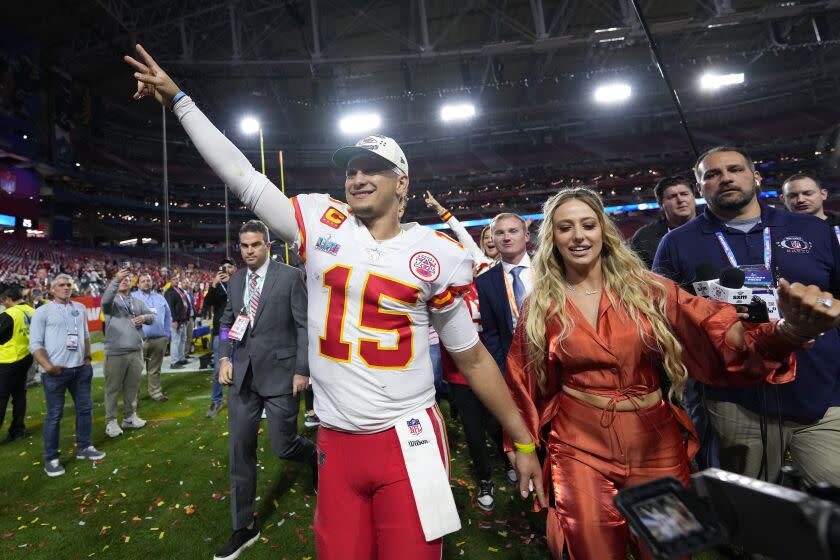 Kansas City Chiefs quarterback Patrick Mahomes (15) leaves the field with his wife Brittany