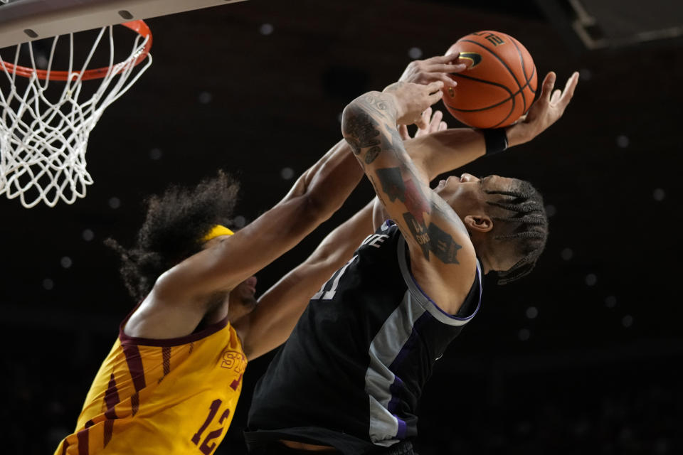 Kansas State forward Keyontae Johnson is fouled by Iowa State forward Robert Jones (12) while driving to the basket during the second half of an NCAA college basketball game, Tuesday, Jan. 24, 2023, in Ames, Iowa. (AP Photo/Charlie Neibergall)