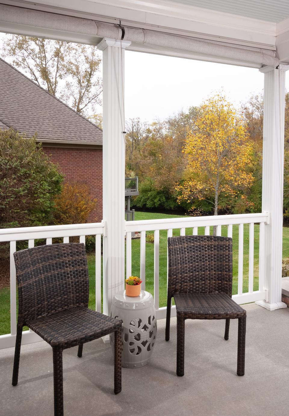 This covered brick porch and patio in Lyndon is outfitted in colors that have been pulled from other parts of the house.