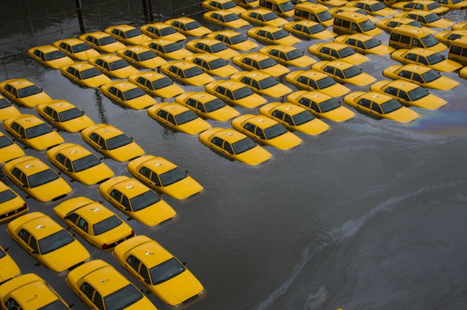 A parking lot full of yellow cabs is flooded as a result of superstorm Sandy on Tuesday, Oct. 30, 2012 in Hoboken, NJ. (AP Photo/Charles Sykes)