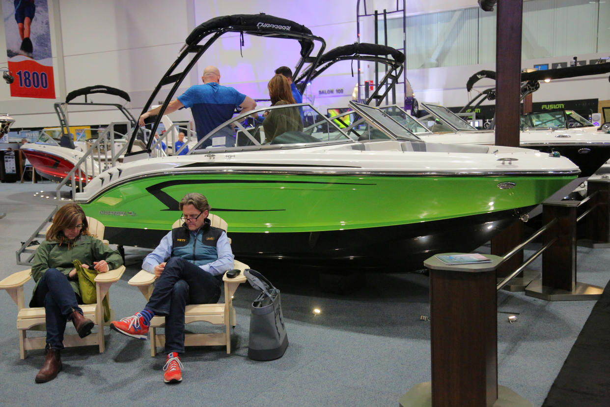 A couple sit in Adirondack chairs at the Chaparral powerboat display at the Toronto Boat Show in Toronto, Ontario, Canada January 18, 2019.   REUTERS/Chris Helgren