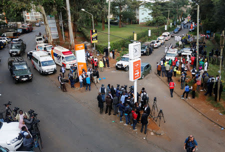 Journalists and rescue workers are seen near the scene where explosions and gunshots were heard at the Dusit hotel compound in Nairobi, Kenya, January 16, 2019. REUTERS/Thomas Mukoya