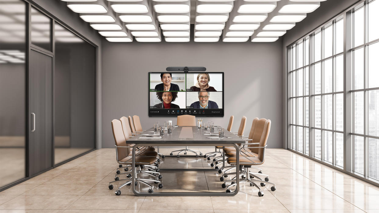  Avocor and Logitech bring a conferencing solution shown here in a large conference room with four smiling faces videoconferencing in. 