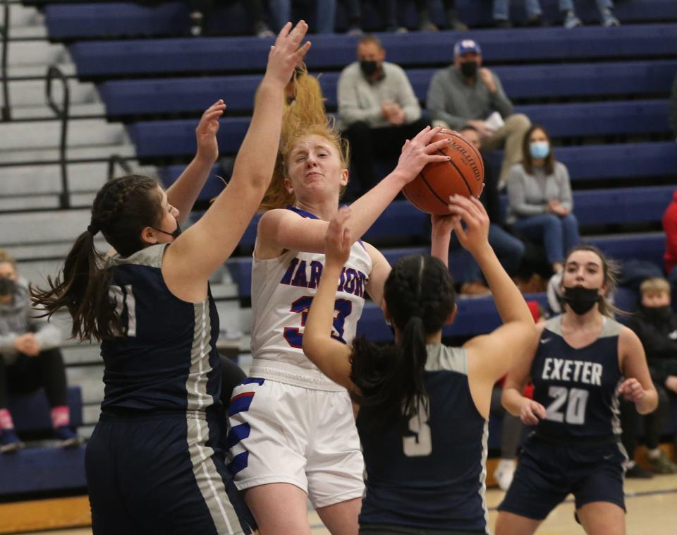 Winnacunnet's Casey Coleman pulls down a rebound against Exeter during Friday's Division I girls basketball game in Hampton.