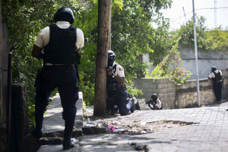 Police search the Morne Calvaire district of Petion Ville for suspects who remain at large in the murder of Haitian President Jovenel Moise in Port-au-Prince, Haiti, Friday, July 9, 2021. Moise was assassinated on July 7 after armed men attacked his private residence and gravely wounded his wife, first lady Martine Moise. (AP Photo/Joseph Odelyn)