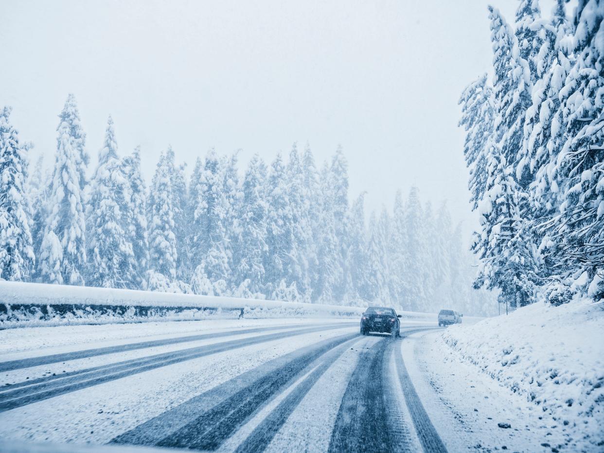 Cars driving on snowy remote road