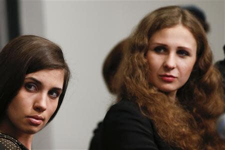 Nadezhda Tolokonnikova (L) and Maria Alyokhina, members of Russian punk rock band Pussy Riot, listens during a news conference before the Amnesty International Bringing Human Rights Home concert in New York February 5, 2014. REUTERS/Shannon Stapleton