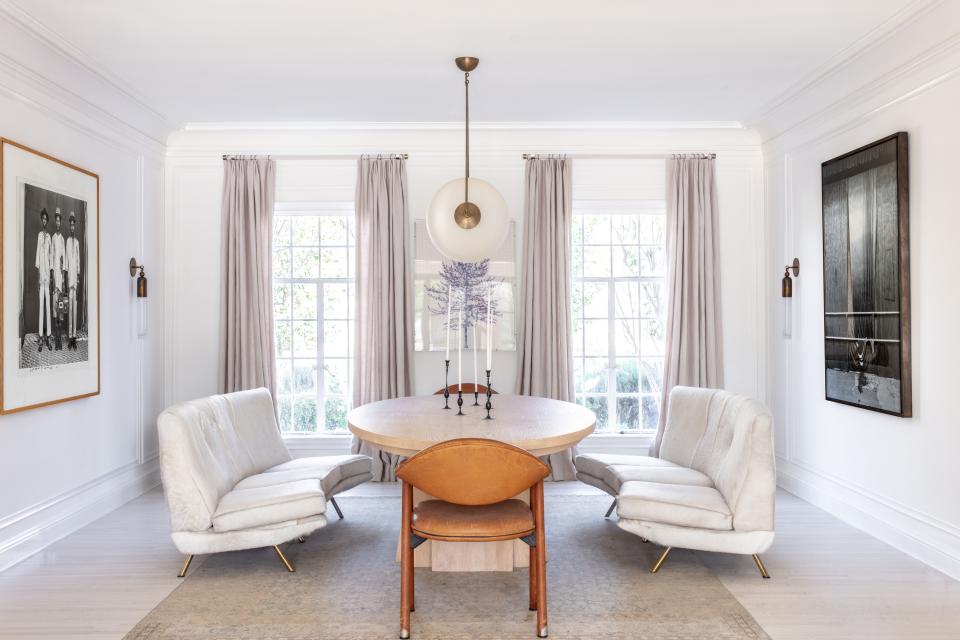 white dining room with white sofas by Brigette Romanek