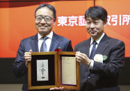 CORRECTS NAME OF KONUMA - SoftBank Corp.'s CEO Ken Miyauchi, left, poses with Yasuyuki Konuma, director and executive officer of Tokyo Stock Exchange during a ceremony at the Tokyo Stock Exchange in Tokyo, Wednesday, Dec. 19, 2018. SoftBank Group Corp.'s Japanese mobile subsidiary began trading on the Tokyo Stock Exchange on Wednesday in one of the world's biggest share offerings. (AP Photo/Koji Sasahara)