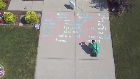 Every year, Joe Spangler uses red, white and blue sidewalk chalk to cover his Fishers driveway with the Declaration of Independence.