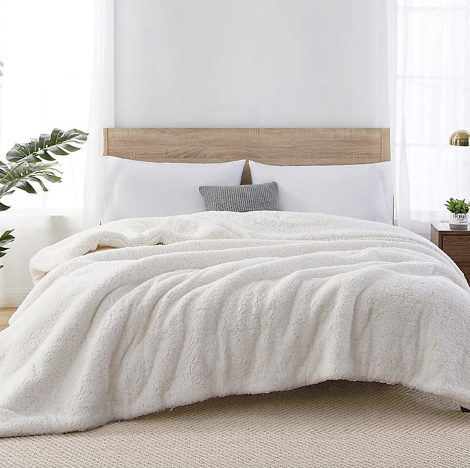 white Sherpa Reversible Comforter with white pillows 