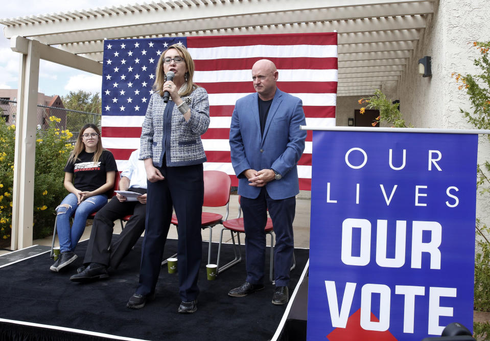 In this Oct. 2, 2018 photo, former Rep. Gabby Giffords speaks as her husband, retired NASA astronaut and Navy Capt. Mark Kelly looks on as they kick off "The Vote Save Lives" tour at UNLV in Las Vegas. The 2018 election marks the first time that groups supporting gun control measures could spend more on a campaign than the National Rifle Association. (Bizuayehu Tesfaye/Las Vegas Review-Journal via AP)/Las Vegas Review-Journal via AP)