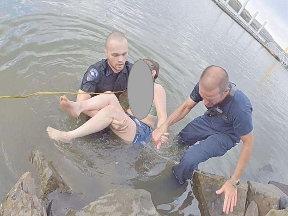 Officer Reams (left) rescued the trapped swimmer from the Columbia River in Oregon on 15 June, 2022 (City of The Dalles Police Department)