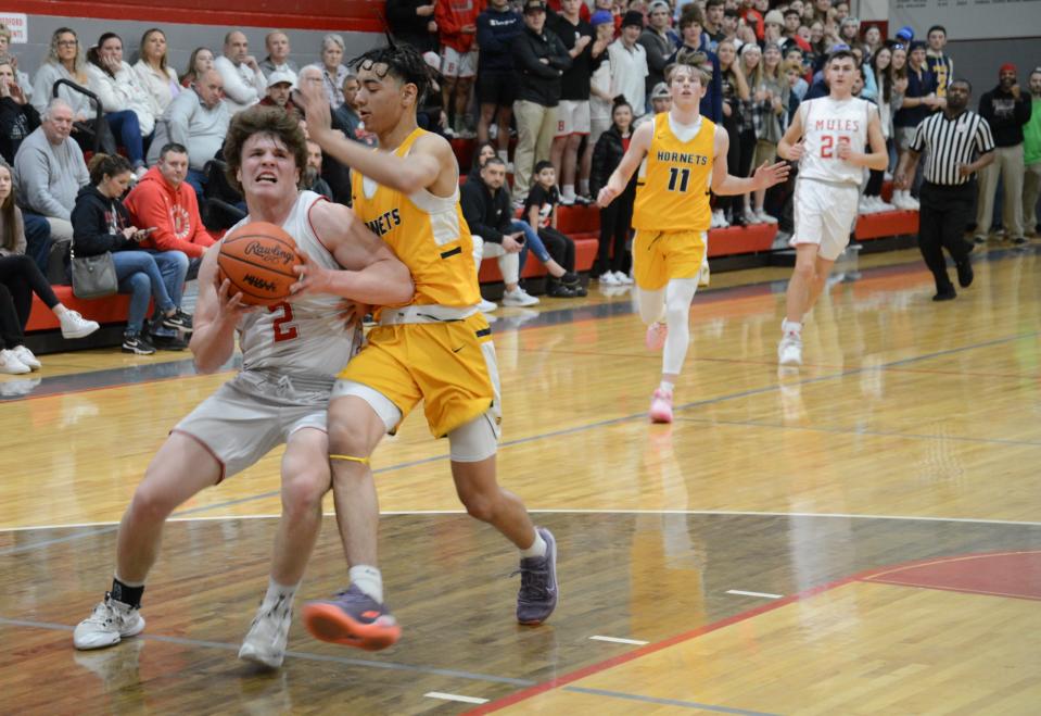 Tommy Huss of Bedford drives on Saline's Harrison Rogers Friday night. Bedford won 54-53.