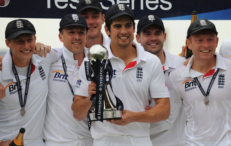 England's Alastair Cook (C) holds the trophy with teammates as England celebrates a series win on the fifth day in the second international cricket Test match between England and New Zealand at Headingly in Leeds on May 28, 2013. Graeme Swann bowled England to a commanding 247-run in the second Test against New Zealand in Leeds on Tuesday with rain unable to save the tourists