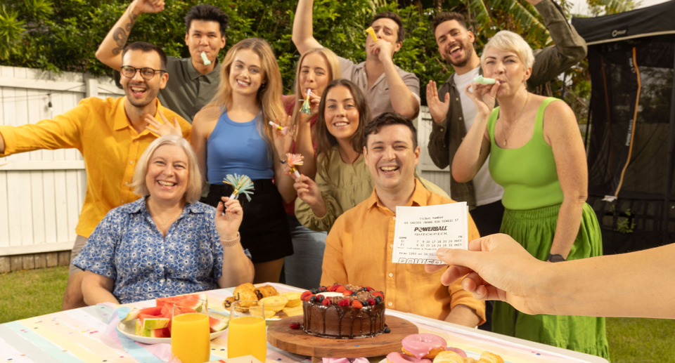 A group of family and friends celebrate a lottery win, ahead of tonight's $100 million Powerball draw. 