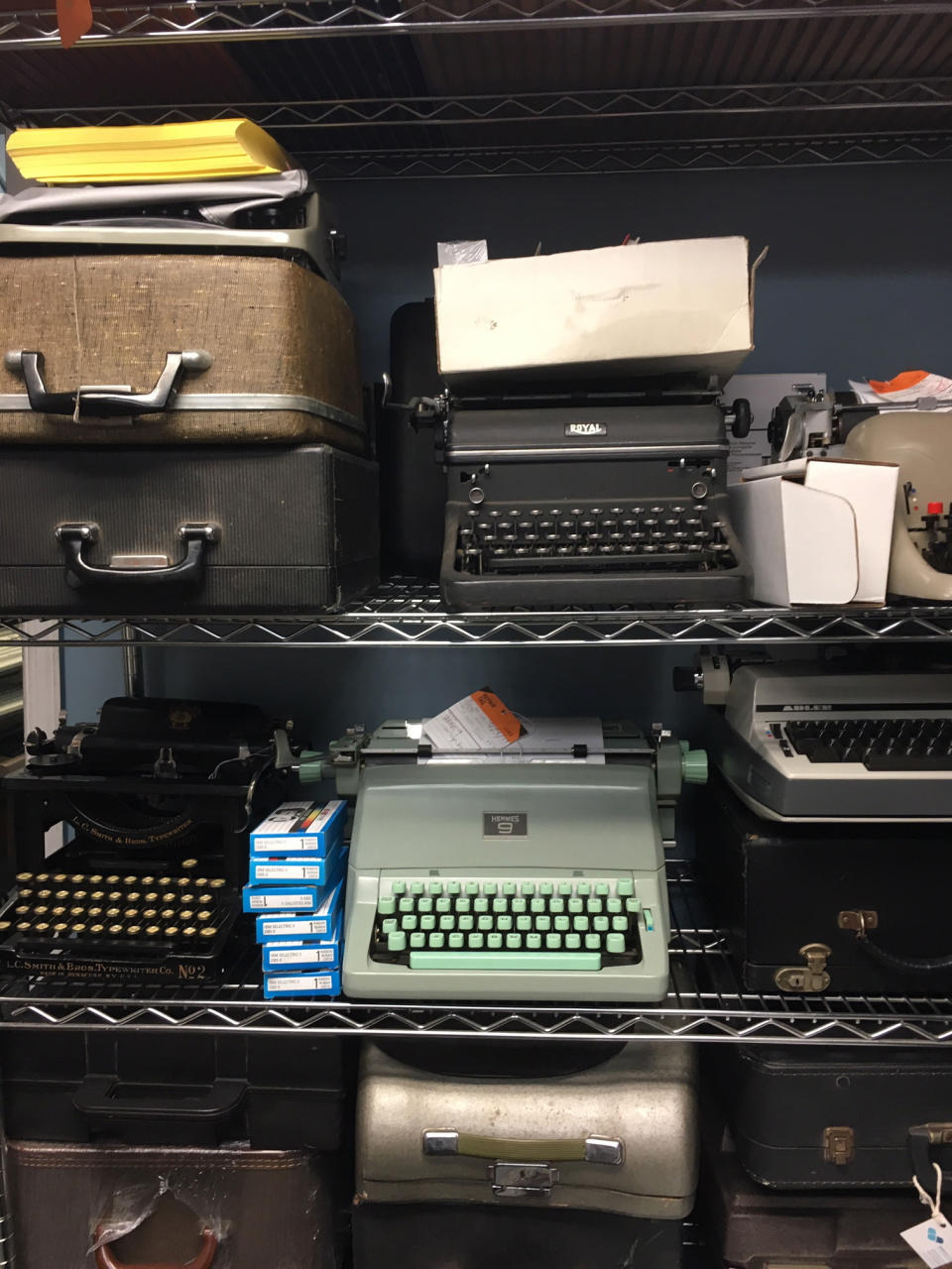 This June 28, 2019 photo shows a shelf of vintage typewriters in the repair shop of the Gramercy Typewriter Co., in New York. Vintage typewriters are sent for repair and restoration daily from around the country, the stores owner says. (Katherine Roth via AP)