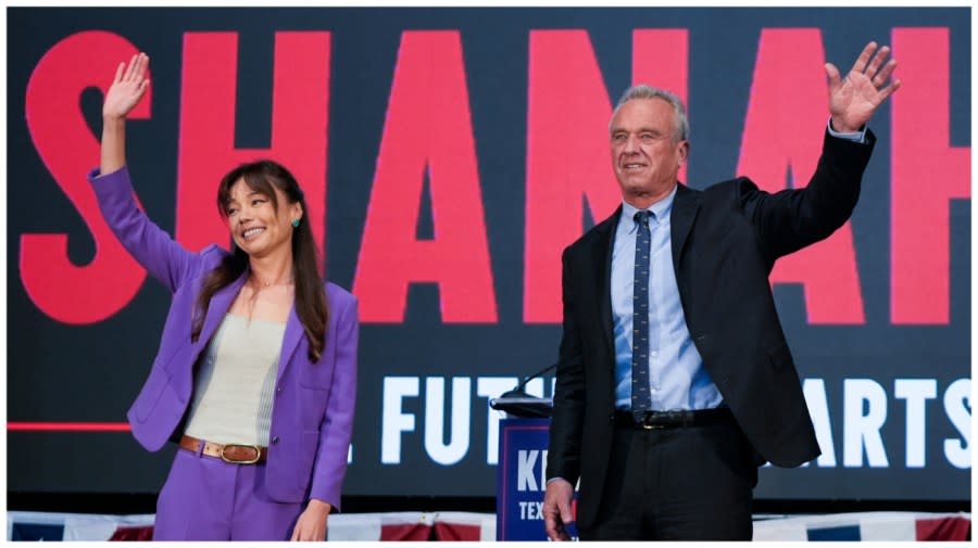 Presidential candidate Robert F. Kennedy Jr. right, waves on stage with Nicole Shanahan.