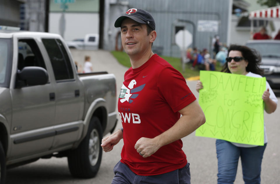 In this June 10, 2018 photo, Minnesota 1st District congressional candidate Dan Feehan works a parade in Waterville, Minn. Waterville's 54th annual Bullhead Days parade included Democrat Feehan and Republican Jim Hagedorn, candidates who came to shake as many hands as they could in the open seat race which promises to be one of the most closely watched races in the country. (AP Photo/Jim Mone) (AP Photo/Jim Mone)