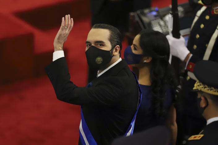 FILE - In this June 1, 2021 file photo, El Salvador's President Nayib Bukele waves during his annual address to the nation to congress, in San Salvador, El Salvador. Bukele's presidency so far is the story of one of Latin America's newest populist autocracies in the making: spending big to hand out goodies, branding opponents as enemies, raising the profile of the military. (AP Photo/Salvador Melendez, File)