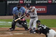 Houston Astros' Alex Bregman (2) hits a one-run single off Chicago White Sox pitcher Michael Kopech (34) in the fourth inning during Game 3 of a baseball American League Division Series Sunday, Oct. 10, 2021, in Chicago. (AP Photo/Charles Rex Arbogast)