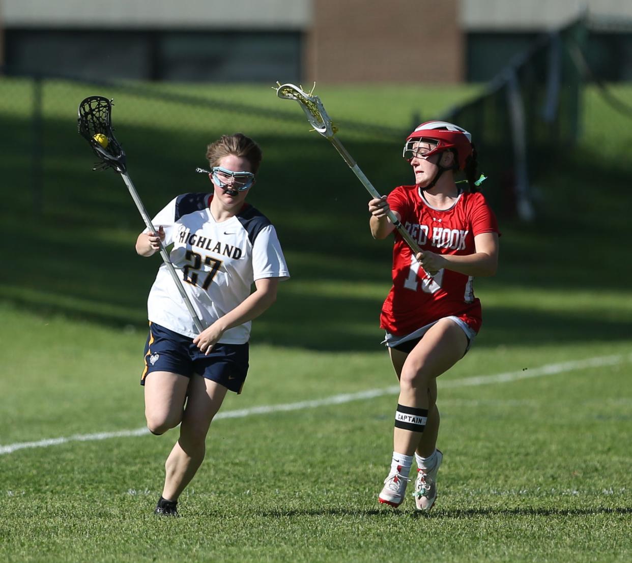 Highland's Sophie Murtaugh carries the ball up field while guarded by Red Hook's Yianna Giannoulis during a May 8, 2024 girls lacrosse game.