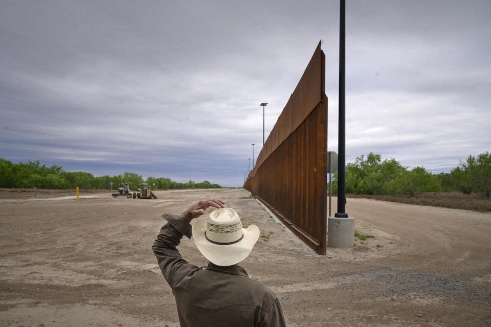 A ranch owner looks at portion of the unfinished border wall that former President Donald Trump tried to build, near the southern Texas border city of Roma in Starr County. (Ed Jones / AFP via Getty Images)