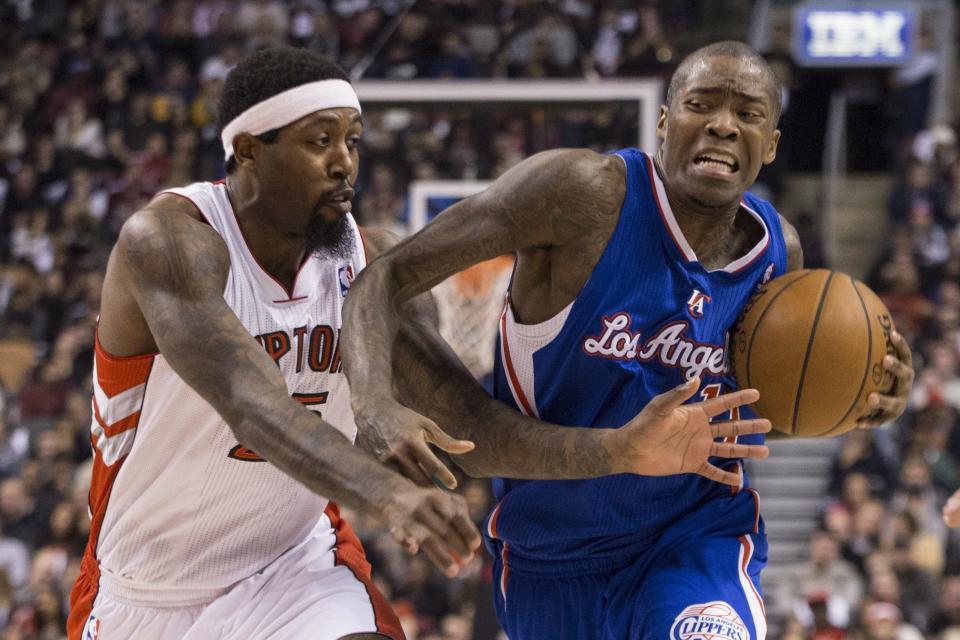 Los Angeles Clippers' Jamal Crawford, right, drives past Toronto Raptors' John Salmons during the first half of an NBA basketball game, Saturday, Jan. 25, 2014 in Toronto. (AP Photo/The Canadian Press, Chris Young)