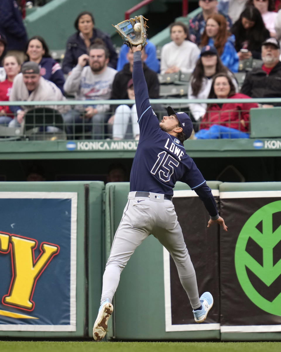 Tampa Bay Rays right fielder Josh Lowe makes the play on a flyout by Boston Red Sox's Enrique Hernandez during the seventh inning of a baseball game at Fenway Park, Monday, June 5, 2023, in Boston. (AP Photo/Charles Krupa)