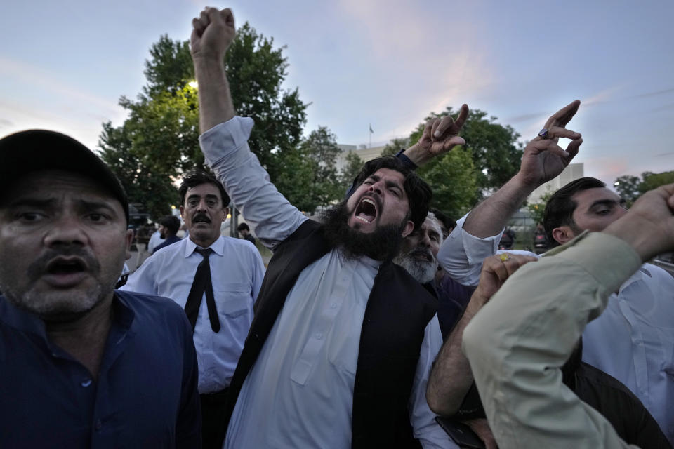 Supporters of Pakistan's former Prime Minister Imran Khan chant slogans outside Supreme Court as they celebrate after court decision, in Islamabad, Pakistan, Thursday, May 11, 2023. Pakistan’s Supreme Court has ordered the release of Khan, whose arrest earlier this week sparked a wave of violence across the country by his supporters. (AP Photo/Anjum Naveed)