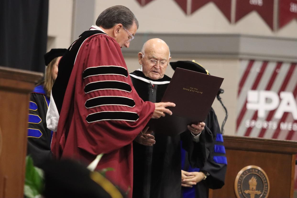 Mr. Paul F. Engler receives an honorary Ph.D. in business administration and agriculture from both colleges that bear his name during the West Texas A&M University graduation ceremonies Saturday at the First United Bank Center in Canyon.