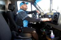 Joseph Alvarado in the driver seat as he makes deliveries for Amazon during the outbreak of the coronavirus disease