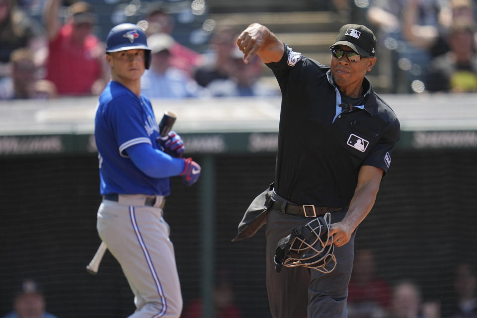 Toronto Blue Jays' Matt Chapman, left, looks on as home plate umpire Jeremie Rehak, right, ejects George Springer from the game in the seventh inning of a baseball game against the Cleveland Guardians, Thursday, Aug. 10, 2023, in Cleveland. (AP Photo/Sue Ogrocki)