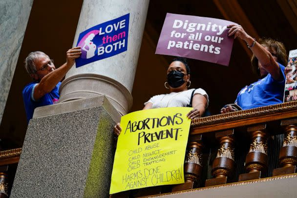 PHOTO: Anti-abortion supporters try to cover a sign of an abortion rights supporter during an anti-abortion during a hearing at the Statehouse in Indianapolis, July 26, 2022. (Michael Conroy/AP)