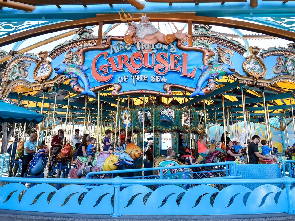 A blue carousel with undersea animals and waves.