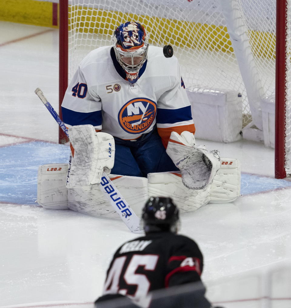 New York Islanders goaltender Semyon Varlamov makes a save on a shot from Ottawa Senators left wing Parker Kelly during the second period of an NHL hockey game, Wednesday, Jan. 25, 2023 in Ottawa, Ontario. (Adrian Wyld/The Canadian Press via AP)