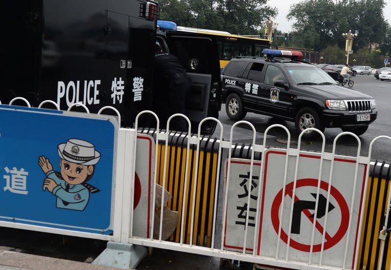 Chinese police monitor visitors to Tiananmen Square in Beijing on June 22, 2013. Tsinghua University, which counts China's President Xi Jinping and his predecessor Hu Jintao among its graduates, was the target of extensive NSA hacking, Edward Snowden says