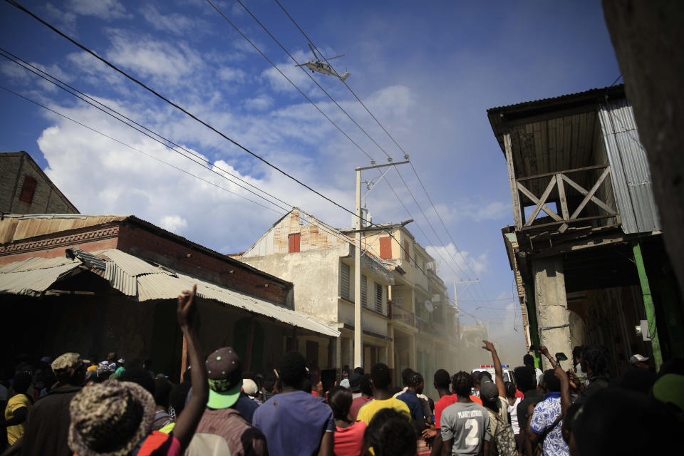 People protest against the arrival of the USNS Comfort hospital ship in Jeremie, Haiti, Tuesday, Dec. 13, 2022. The USNS Comfort is on a humanitarian mission to provide dental and medical services. (AP Photo/Odelyn Joseph)