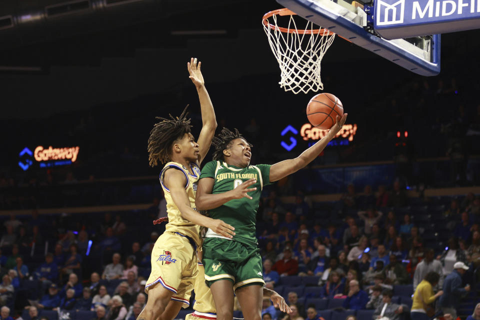 South Florida guard Jayden Reid (0) is fouled Tulsa guard Tyshawn Archie (8) during the first half of an NCAA college basketball game, Saturday, March 9, 2024, in Tulsa, Okla. (AP Photo/Joey Johnson)