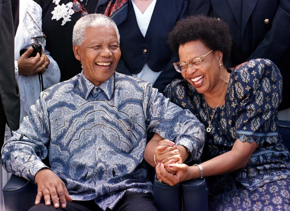President Nelson Mandela and his now wife Graca Machel share a laugh aboard the QE2 cruise liner in this file photo taken March 1998. (Reuters)