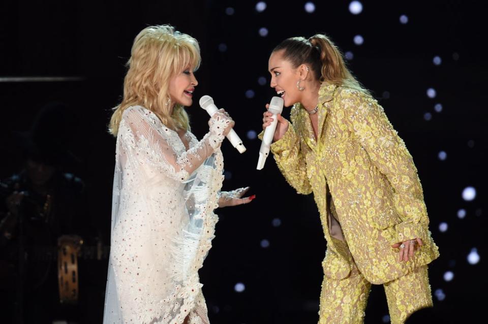 Dolly Parton and Miley Cyrus showed off the true extent of their singing chops as they took to the stage together to sing a duet of ‘Jolene’, in honour of Parton’s prosperous career. The pair both donned dazzling outfits for the performance, Parton in angelic white and Cyrus in a yellow floral suit (Getty)