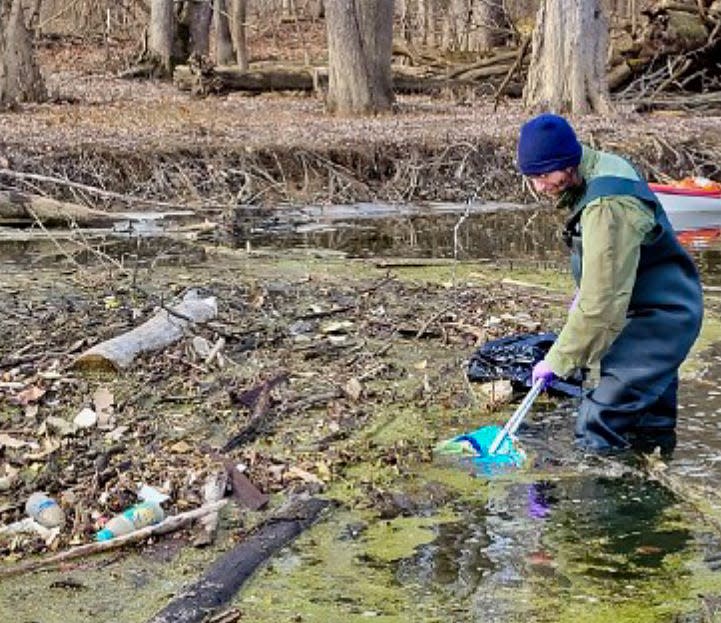 Volunteer Joe Dewan helps remove trash and debris from Lansing's waterways.