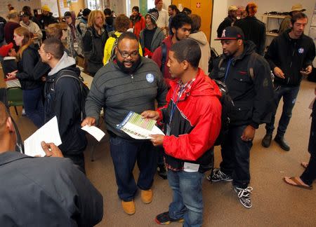 Team leader Solomon Montgomery (C, with glasses) helps canvassers prepare to begin their routes to drum up support for Oregon's Measure 91, which would legalize the recreational use of marijuana in Portland, Oregon October 28, 2014. REUTERS/Steve Dipaola