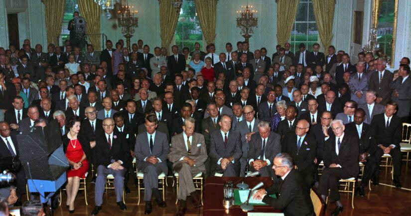 President Lyndon Johnson signs the Civil Rights Act of 1964. (Getty Images)