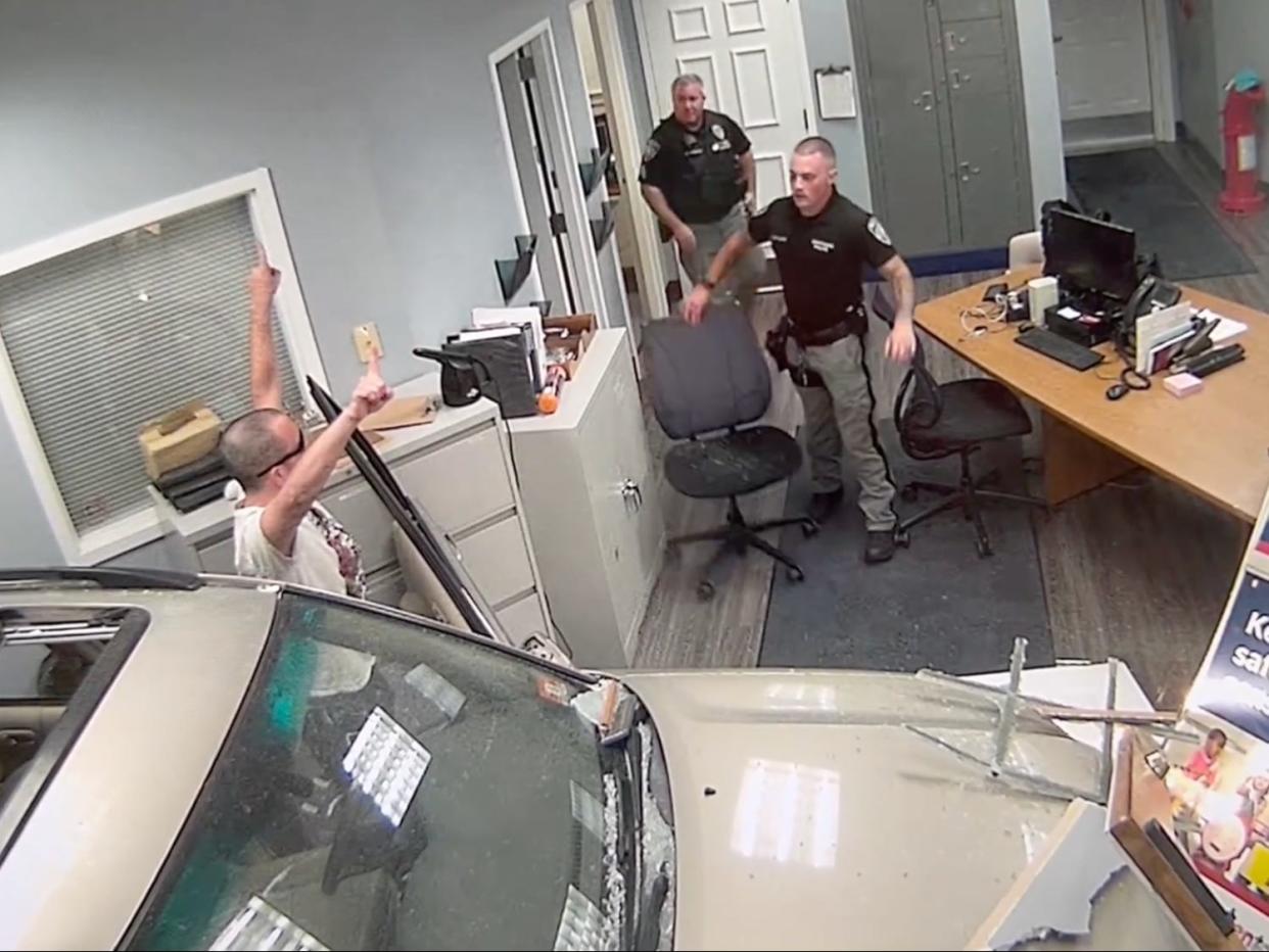 Video footage shows the moment John G. Hargreaves drove his car into a police department squad room.